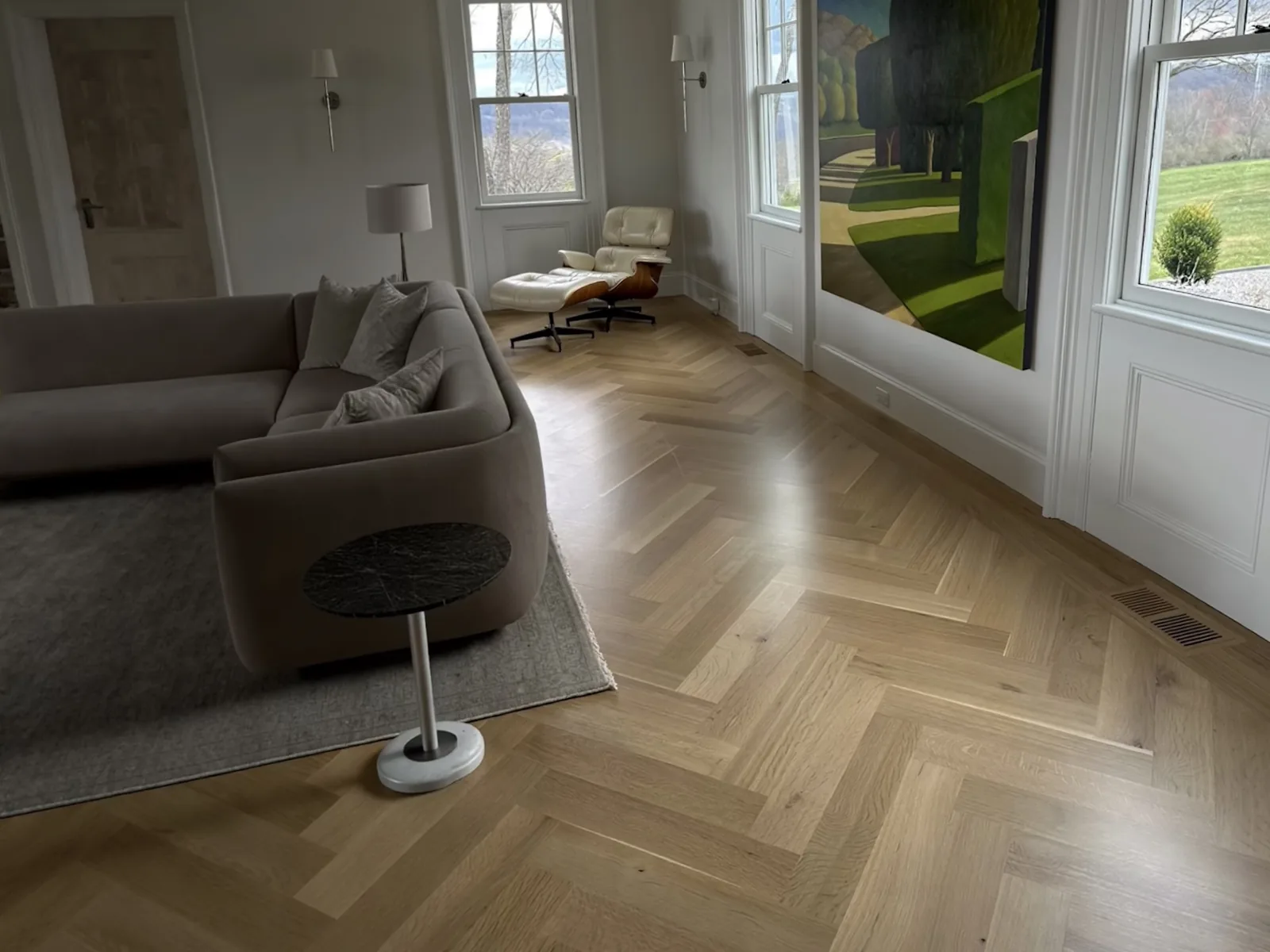 Herringbone hardwood floor running through a New Jersey living room