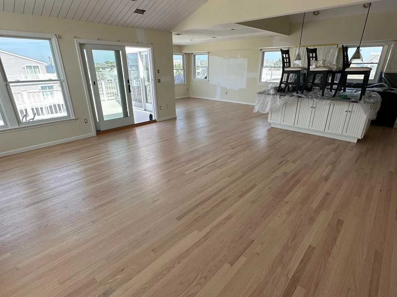 Red oak floor refinished with a natural seal across an open-plan New Jersey home