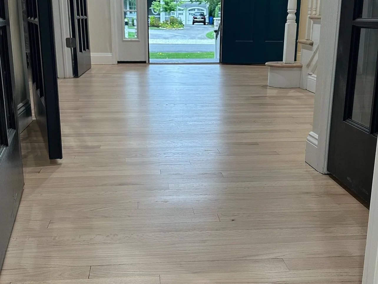 Refinished red oak floor running through a New Jersey front hall