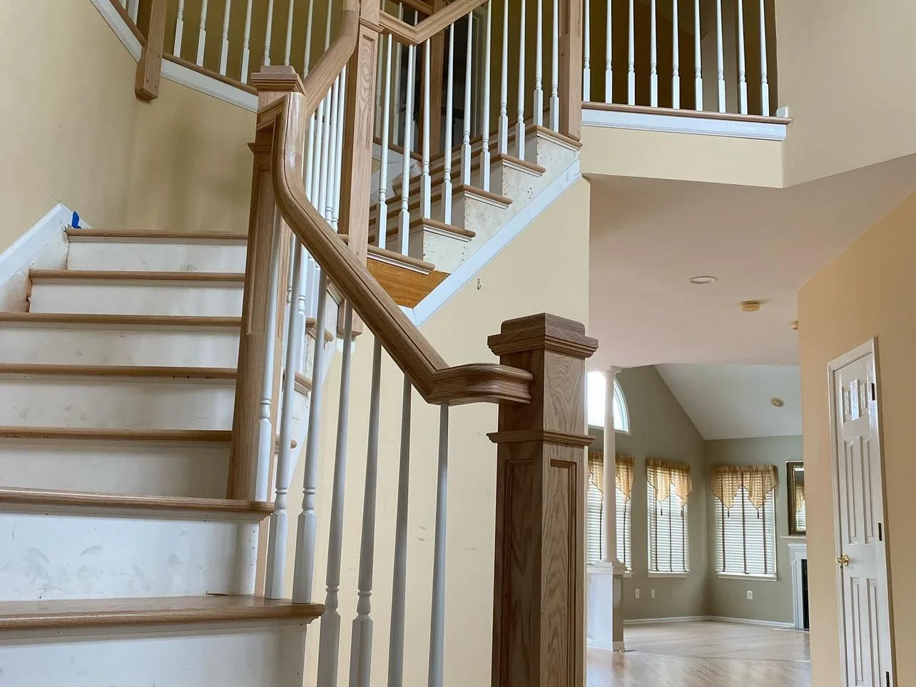 Red oak staircase and landing railing finished with an amber seal